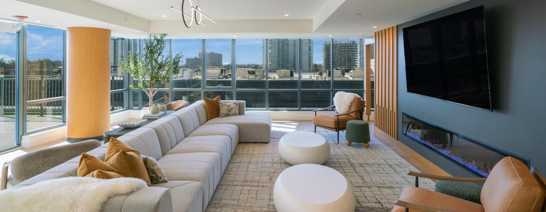 a clubroom with a tv, couch and chairs