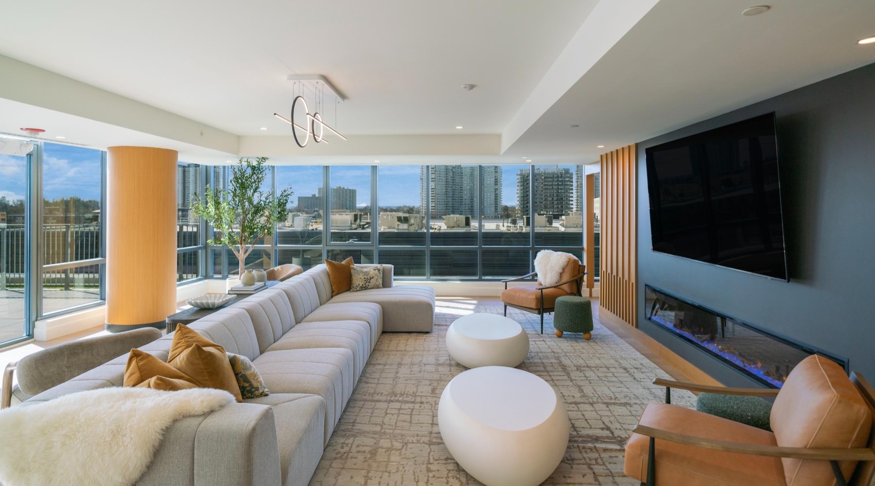 a clubroom with a couch, tv and chairs