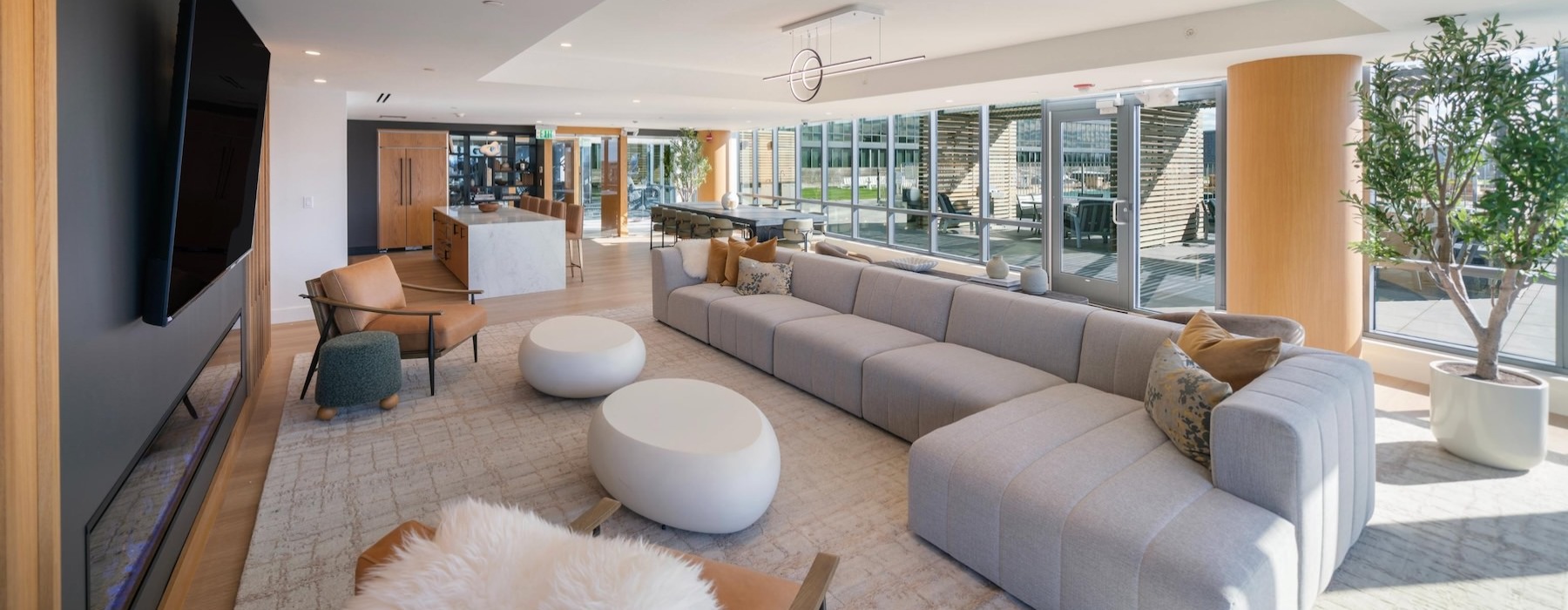 a clubroom with a tv, couch and chairs