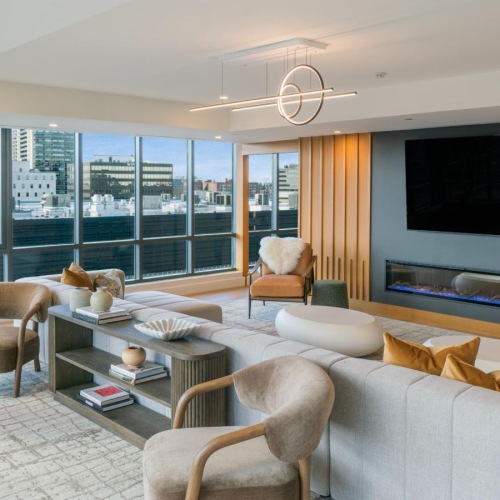 a clubroom with a tv, couch and chairs