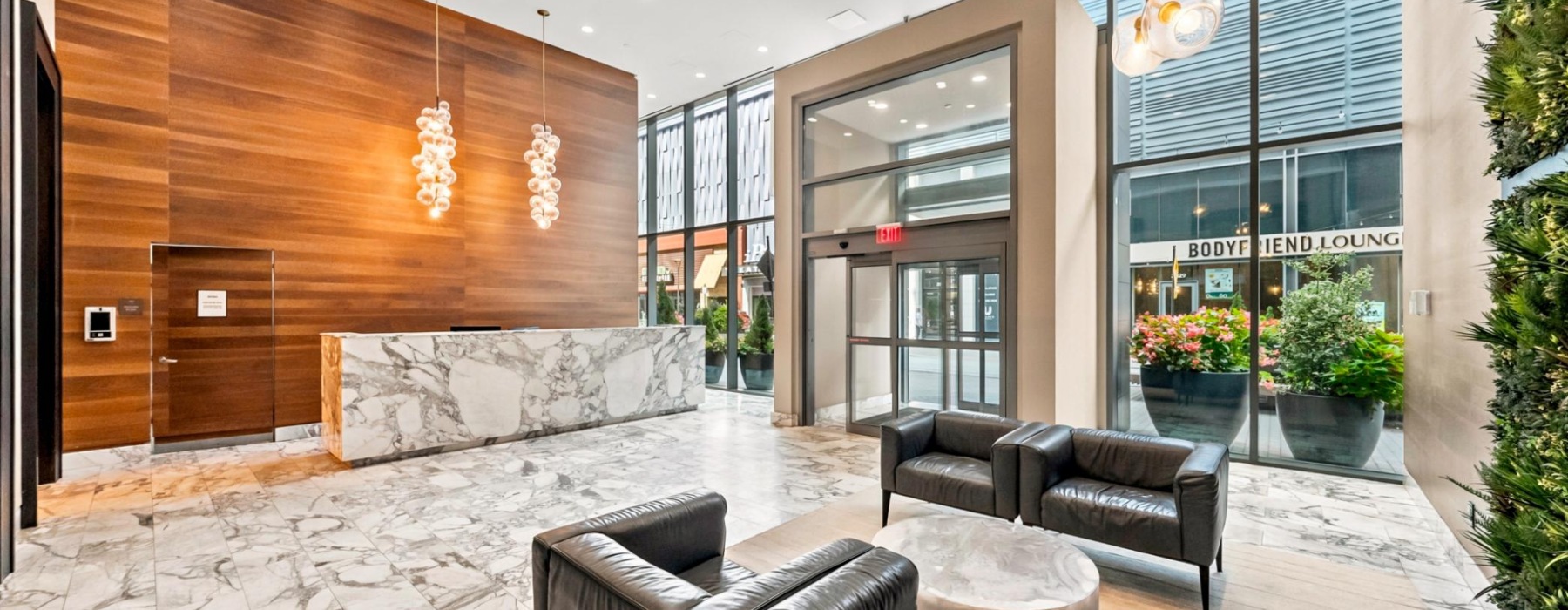 Residential lobby with concierge desk and waiting area