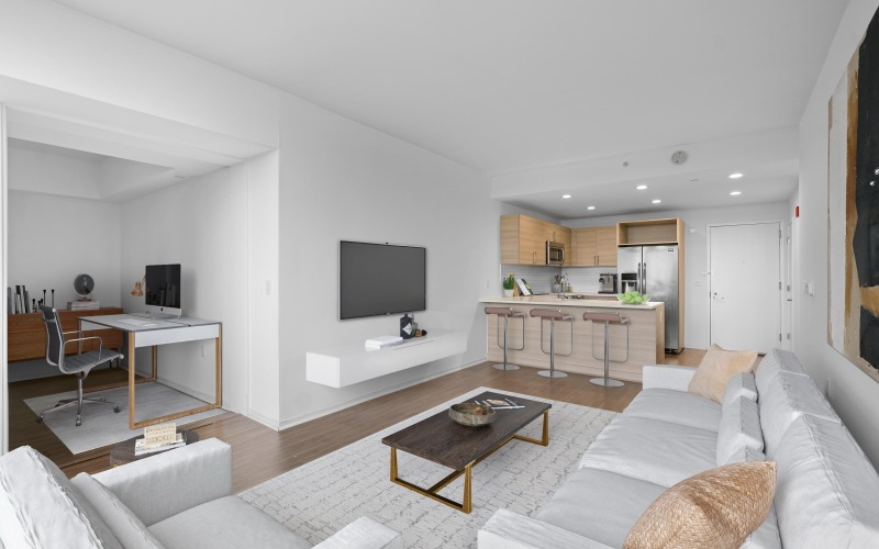 Living room with view of work from home den and kitchen