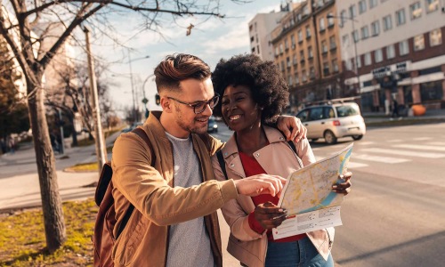 two people walking and looking at a map